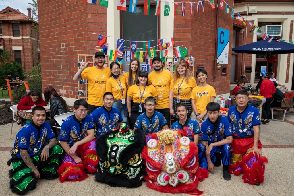 photo showing a group of lion dance performers in colourful costumes